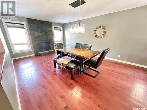 787 Brimacombe Drive, Weyburn, SK - Indoor Photo Showing Dining Room With Fireplace