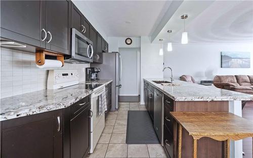 Large Island with Sink  & Breakfast Bar Open to Living Room/Dining Room - 30 Harrisford Street|Unit #1001, Hamilton, ON - Indoor Photo Showing Kitchen With Upgraded Kitchen