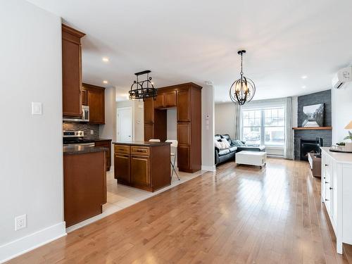 Living room - 115 Rue De Bienville, Châteauguay, QC - Indoor Photo Showing Kitchen With Fireplace