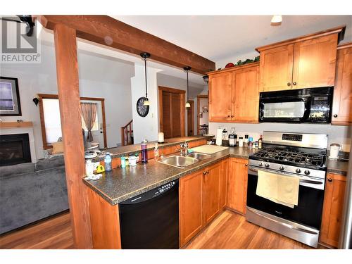 121 Deer Street, Vernon, BC - Indoor Photo Showing Kitchen With Fireplace With Double Sink