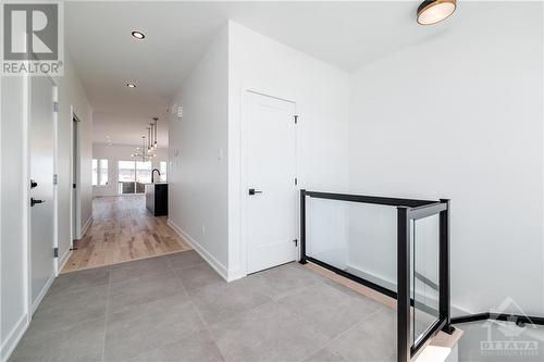 ceramic floor tile and modern glass railings included standard - 1344 Diamond Street, Clarence-Rockland, ON - Indoor Photo Showing Other Room