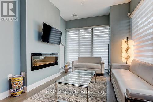 602 - 20 Shore Breeze Drive, Toronto, ON - Indoor Photo Showing Living Room With Fireplace