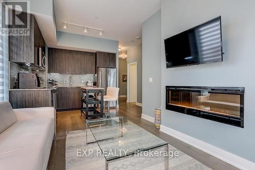 602 - 20 Shore Breeze Drive, Toronto, ON - Indoor Photo Showing Living Room With Fireplace