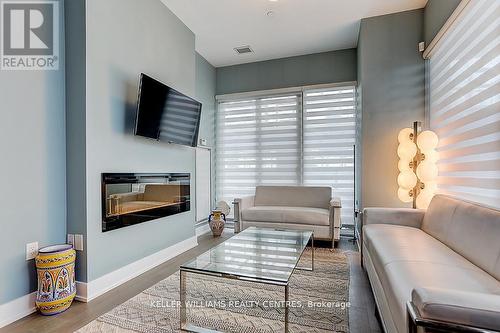 #602 -20 Shore Breeze Dr, Toronto, ON - Indoor Photo Showing Living Room With Fireplace