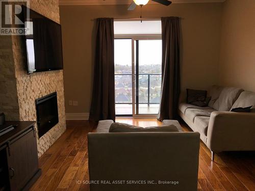 #1303 -240 Villagewalk Blvd, London, ON - Indoor Photo Showing Living Room With Fireplace