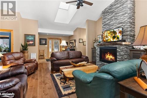 Living Space with Large Sky-Lights & Cathedral Ceiling - 1083 Riding Ranch Road, Machar Twp, ON - Indoor Photo Showing Living Room With Fireplace