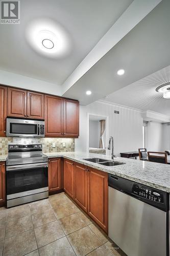 303 - 10101 Yonge Street, Richmond Hill, ON - Indoor Photo Showing Kitchen With Double Sink