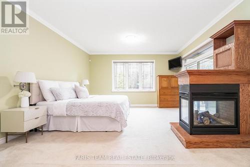 138 Knox Rd E, Wasaga Beach, ON - Indoor Photo Showing Bedroom With Fireplace