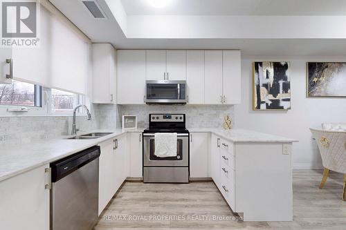 #103 -22 East Haven Dr, Toronto, ON - Indoor Photo Showing Kitchen With Double Sink