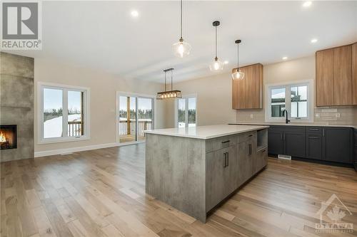 Some photos are virtually staged/digitally altered and NOT the home for sale - similar model by same builder - 178 Danika Street, Hammond, ON - Indoor Photo Showing Kitchen With Fireplace With Upgraded Kitchen