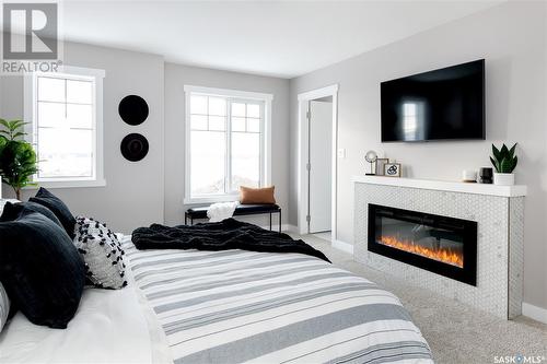282 Schmeiser Bend, Saskatoon, SK - Indoor Photo Showing Bedroom With Fireplace