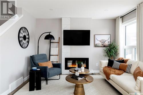 306 Schmeiser Bend, Saskatoon, SK - Indoor Photo Showing Living Room With Fireplace