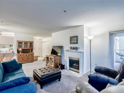 318-1685 Estevan Rd, Nanaimo, BC - Indoor Photo Showing Living Room With Fireplace