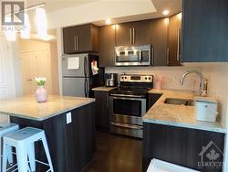 Stainless steel appliances shining among the dark cabinetry - 