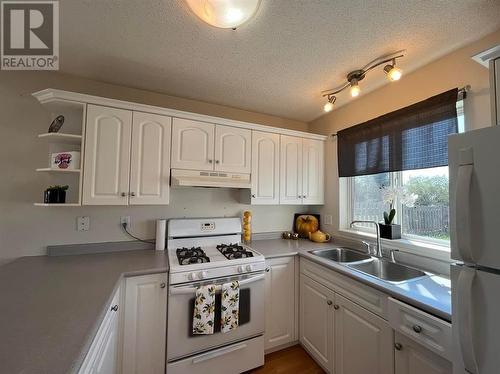 8807-8809 101 Avenue, Fort St. John, BC - Indoor Photo Showing Kitchen With Double Sink