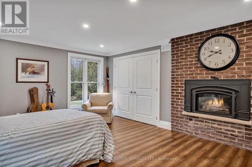 208 Ski Hill Road, Kawartha Lakes, ON - Indoor Photo Showing Bedroom With Fireplace