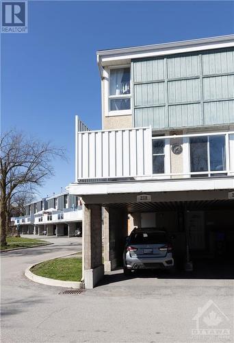 Unit 218 is an end unit that features a carport and a large backyard.  The wood above the carports and above the backyards will soon be replaced with modern materials. Upgrades also include the si - 825 Cahill Drive Unit#218, Ottawa, ON - Outdoor