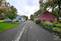 Paved drive-way that leads to a large gravel yard, 2 of 3 sheds for your hobbies or business! - 
