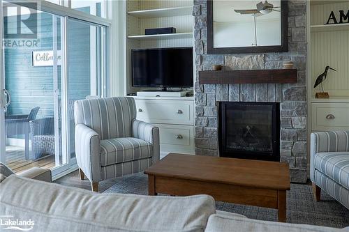 1869 Muskoka Road 118 Highway W Unit# A202-D1, Muskoka Lakes, ON - Indoor Photo Showing Living Room With Fireplace