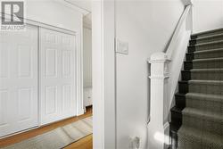 Front door entrance into the self contained upstairs apartment with a large vestibule complete with a huge closet - 