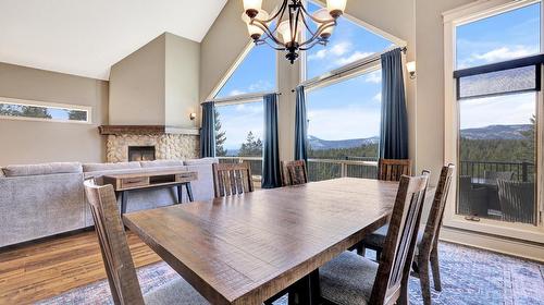 3407 Crooked Tree Place, Fairmont Hot Springs, BC - Indoor Photo Showing Dining Room With Fireplace