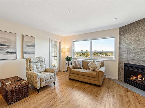 211-1633 Dufferin Cres, Nanaimo, BC - Indoor Photo Showing Living Room With Fireplace