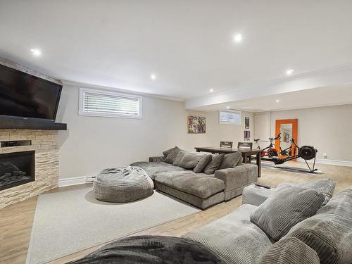 Family room - 48 Rue De Lindoso, Blainville, QC - Indoor Photo Showing Basement With Fireplace