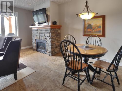 400 Bighorn Boulevard Unit# 425 C, Radium Hot Springs, BC - Indoor Photo Showing Dining Room With Fireplace