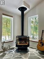 Convenient propane fireplace with gorgeous natural stone makes a perfect corner feature. - 