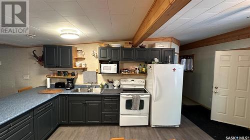 12 Oskunamoo Drive, Greenwater Provincial Park, SK - Indoor Photo Showing Kitchen With Double Sink