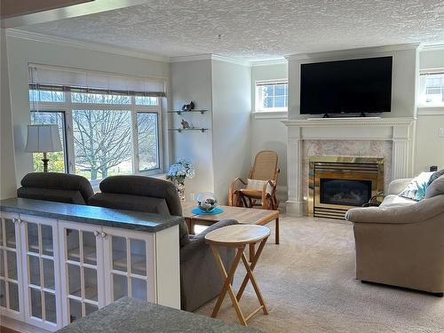 217-4490 Chatterton Way, Saanich, BC - Indoor Photo Showing Living Room With Fireplace