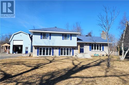 Welcome to this spacious family friendly split level home on a large half acre lot situated moments from St. Andrews West and Cornwall. Notice the massive detached garage- a perfect spot for your - 17021 County Rd 36 Post Road, St Andrews West, ON - Outdoor With Facade
