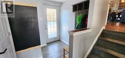 This is the back door leading from the ground level floor. Family friendly features include wall cubby, blackboard for reminders and the second bathroom - 
