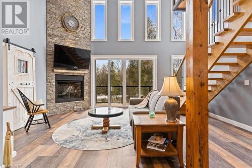 Wall of windows along the river side of the house - 78 Indian Trail, Sauble Beach, ON - Indoor With Fireplace