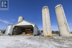 Two 20' x 80' concrete silos for corn silage, feed-room for loading dry-hay and straw onto the conveyor. - 