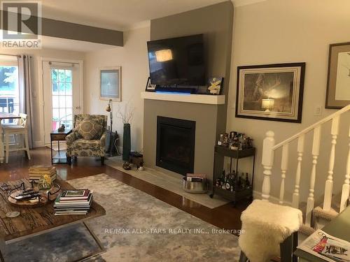 #204 -1 Sherwood St, Kawartha Lakes, ON - Indoor Photo Showing Living Room With Fireplace