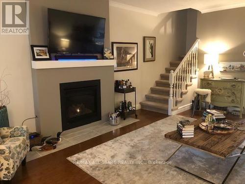 #204 -1 Sherwood St, Kawartha Lakes, ON - Indoor Photo Showing Living Room With Fireplace