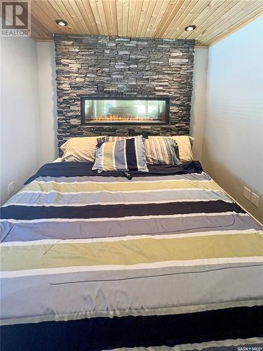 8 Andrews Avenue, Candle Lake, SK - Indoor Photo Showing Bedroom With Fireplace
