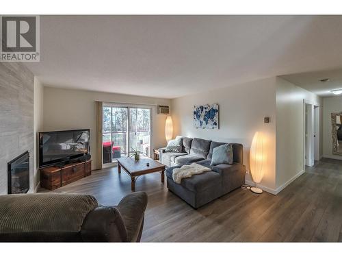 110 Skaha Place Unit# 410, Penticton, BC - Indoor Photo Showing Living Room With Fireplace