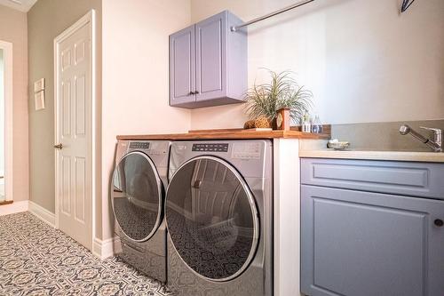 Washer, Dryer, Sink, Flooring, Cabinets + Door Drafts were added to Main Floor Laundry/Mudroom in 2022 - 1652 Roundleaf Court, Burlington, ON - Indoor Photo Showing Laundry Room