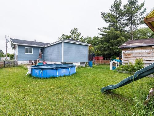 Back facade - 560 Av. Dumais, Saint-Pascal, QC - Outdoor With Above Ground Pool With Backyard With Exterior