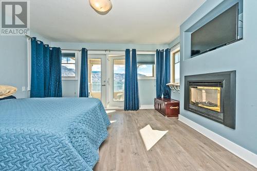 21 Osprey Place, Osoyoos, BC - Indoor Photo Showing Bedroom With Fireplace