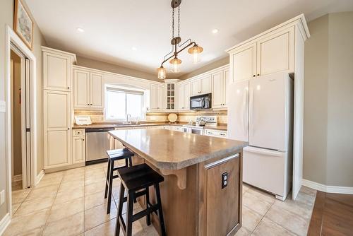 Just-perfect kitchen with movable island. - 24 Lakeridge Boulevard, Lowbanks, ON - Indoor Photo Showing Kitchen With Upgraded Kitchen