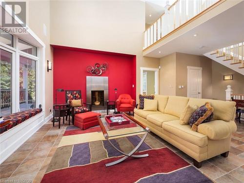 Warm up by the fireplace or read a good book - 90 Greenough Point Road, Northern Bruce Peninsula, ON - Indoor Photo Showing Living Room With Fireplace