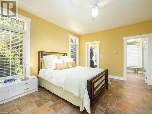 Primary bedroom features a walkout to the covered deck - 90 Greenough Point Road, Northern Bruce Peninsula, ON - Indoor Photo Showing Bedroom