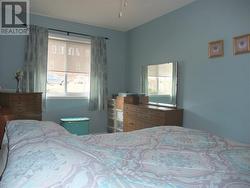 Primary bedroom with a large window. - 