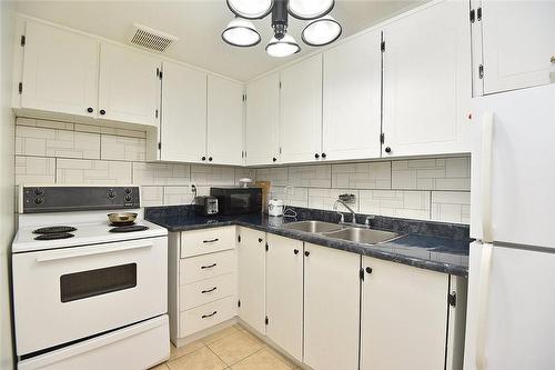 150 Charlton Avenue E|Unit #504, Hamilton, ON - Indoor Photo Showing Kitchen With Double Sink