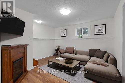 43 Queen Street E, Springwater, ON - Indoor Photo Showing Living Room With Fireplace