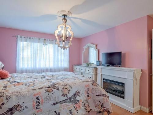 5261 Sandhills Drive, Kelowna, BC - Indoor Photo Showing Bedroom With Fireplace