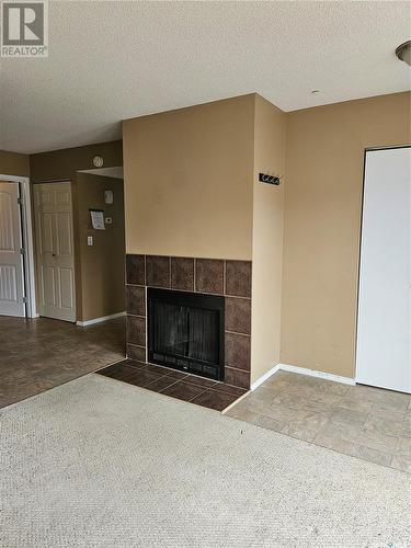 110 517 Albert Street, Estevan, SK - Indoor Photo Showing Living Room With Fireplace